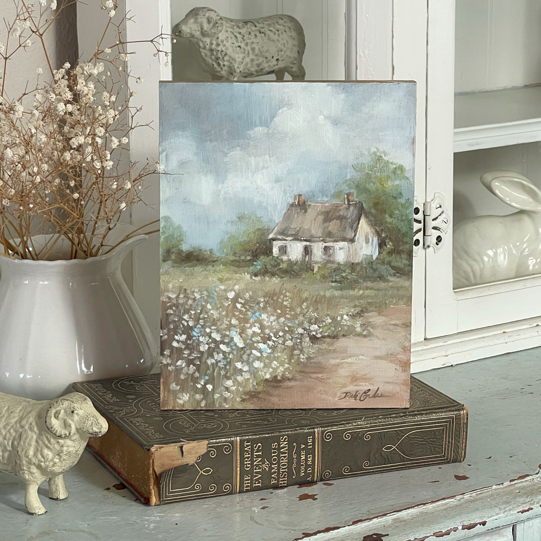 Original oil painting of a pastoral English cottage surrounded by blossoming wildflowers