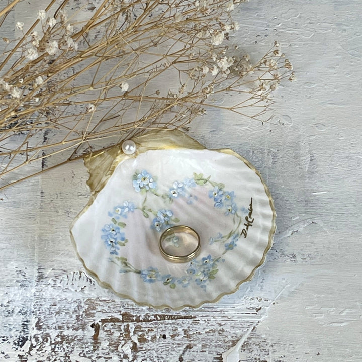 Romantic cottagecore seashell art with forget-me-nots
