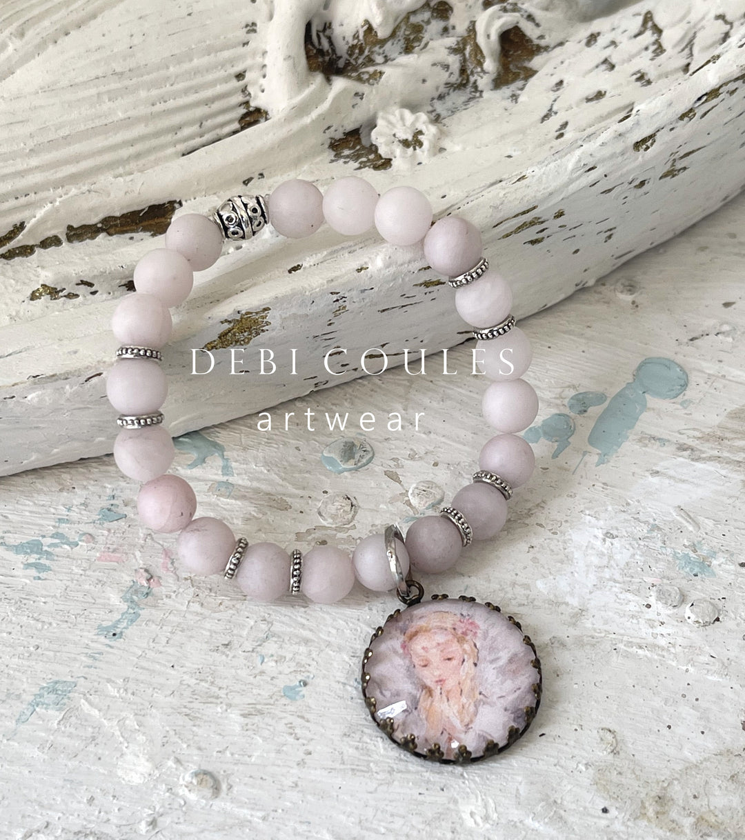 Angel bracelet with pink rose quartz and Tibetan Silver accents. Beautiful angel praying charm set in an antique bronze pronged charm.