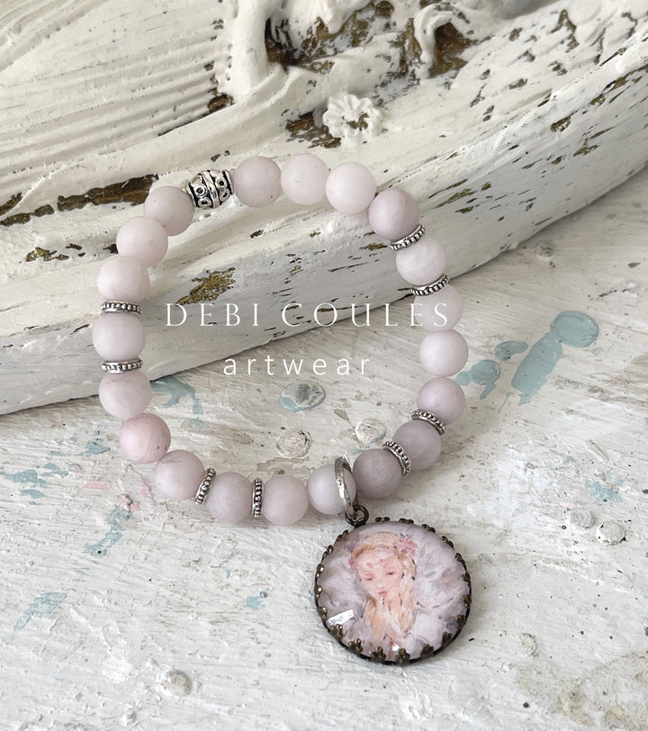 Angel bracelet with pink rose quartz and Tibetan Silver accents. Beautiful angel praying charm set in an antique bronze pronged charm.