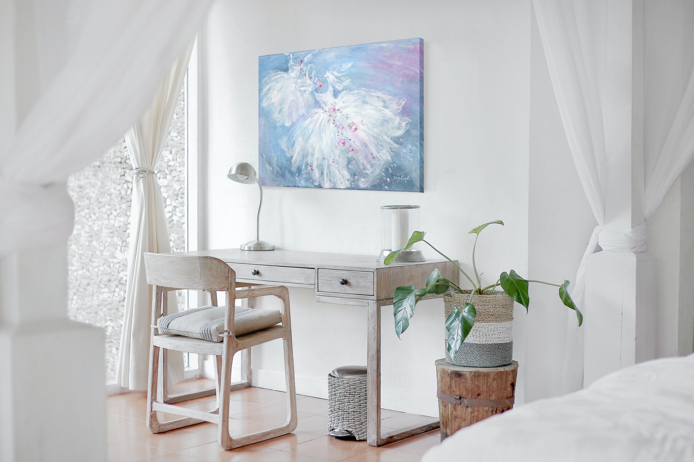 Ballet painting and tutu artwork on display over a desk