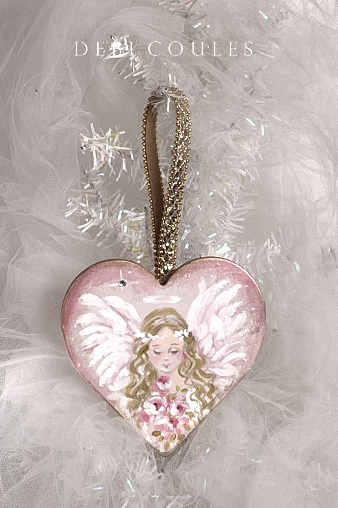 Heart-shaped wood ornament with a blond angel holding a bouquet of pink roses
