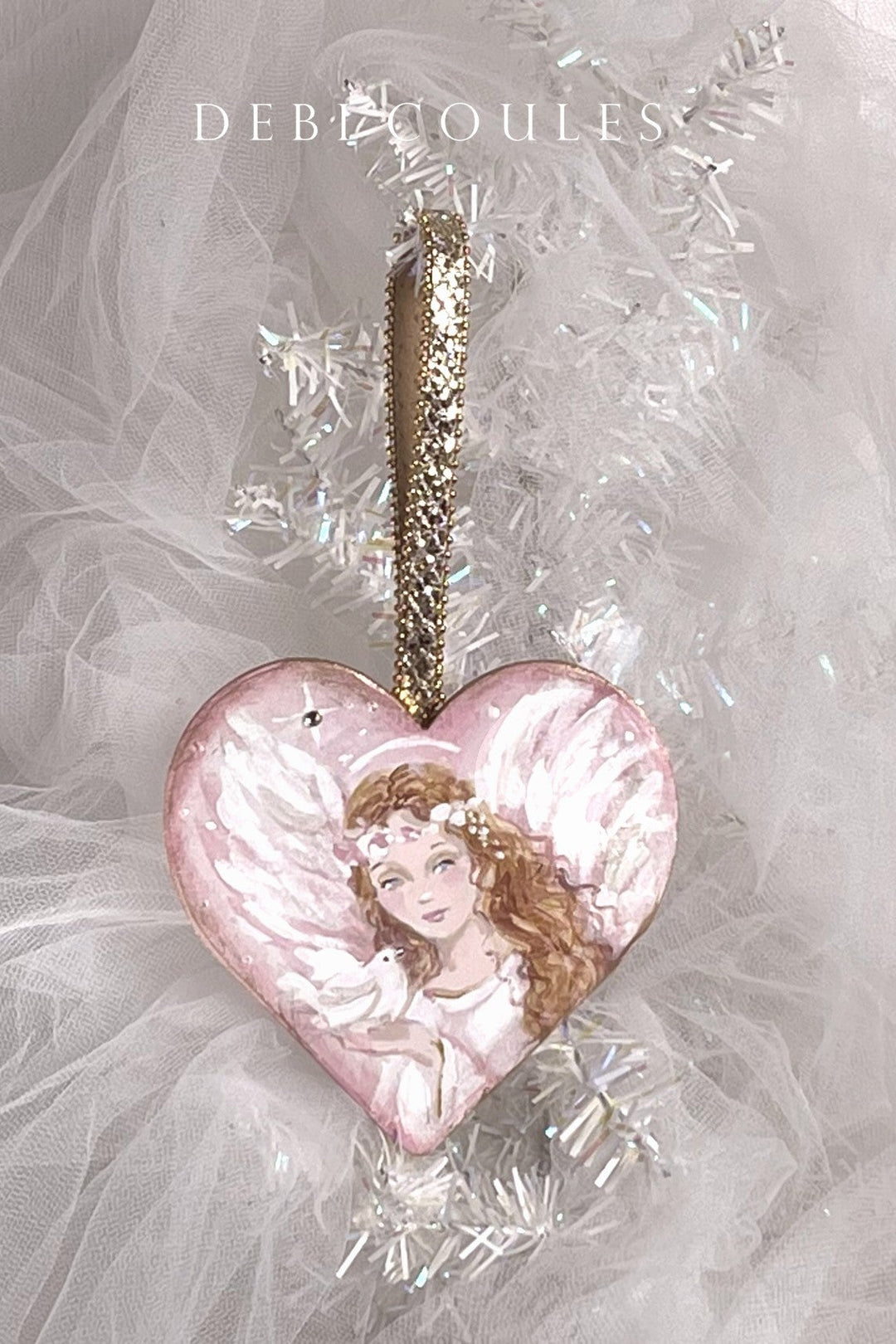 Heart-shaped wood ornament with a pink angel holding a white dove