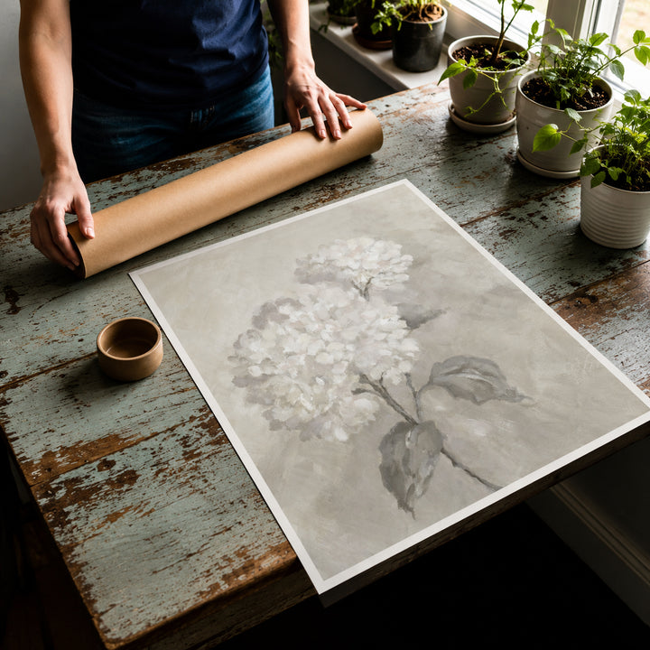 Rolled canvas print shown unrolled on a table with the mailing tube behind