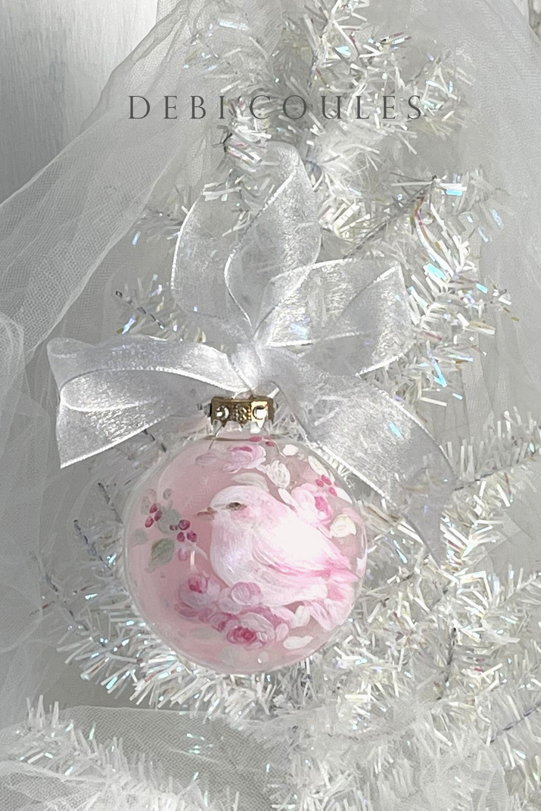 Decorative pink ornament with white dove hand painted on a glass globe