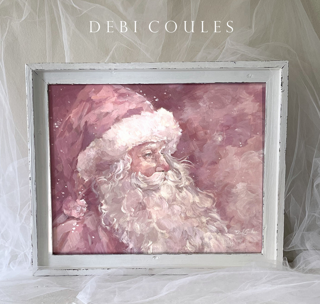 An original painting of a Pink Santa framed in a shabby-chic white farmwood frame