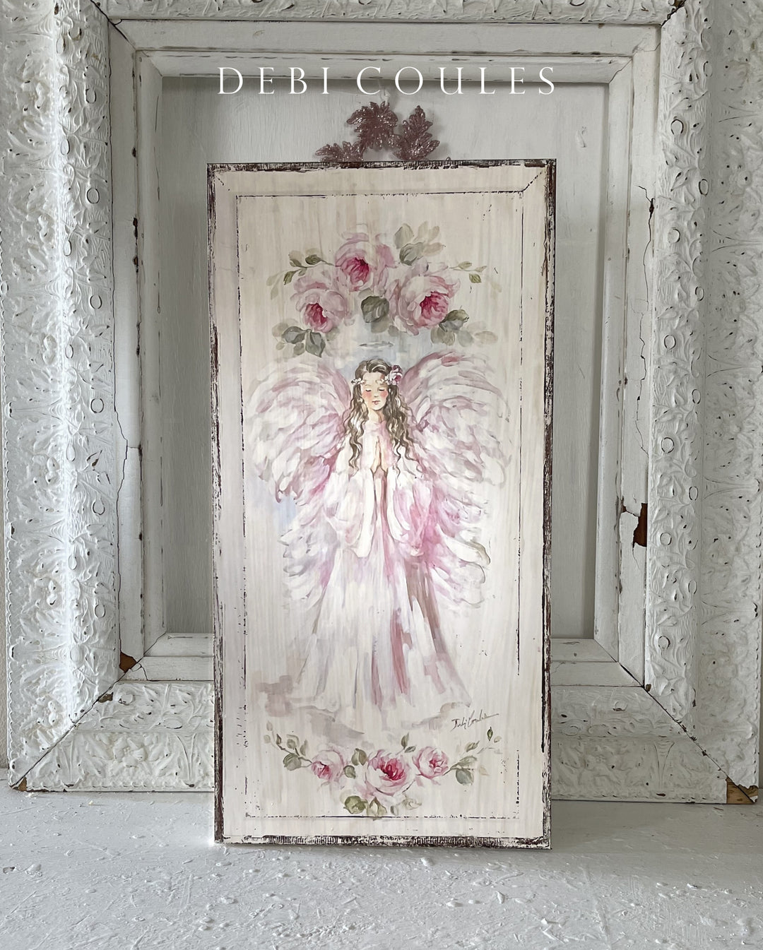 A beautiful shabby-chic painting of a praying pink angel surrounded by roses.