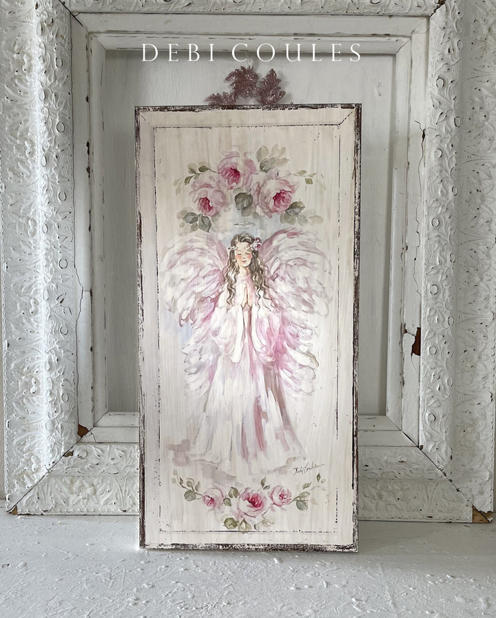 A beautiful shabby-chic painting of a praying pink angel surrounded by roses.