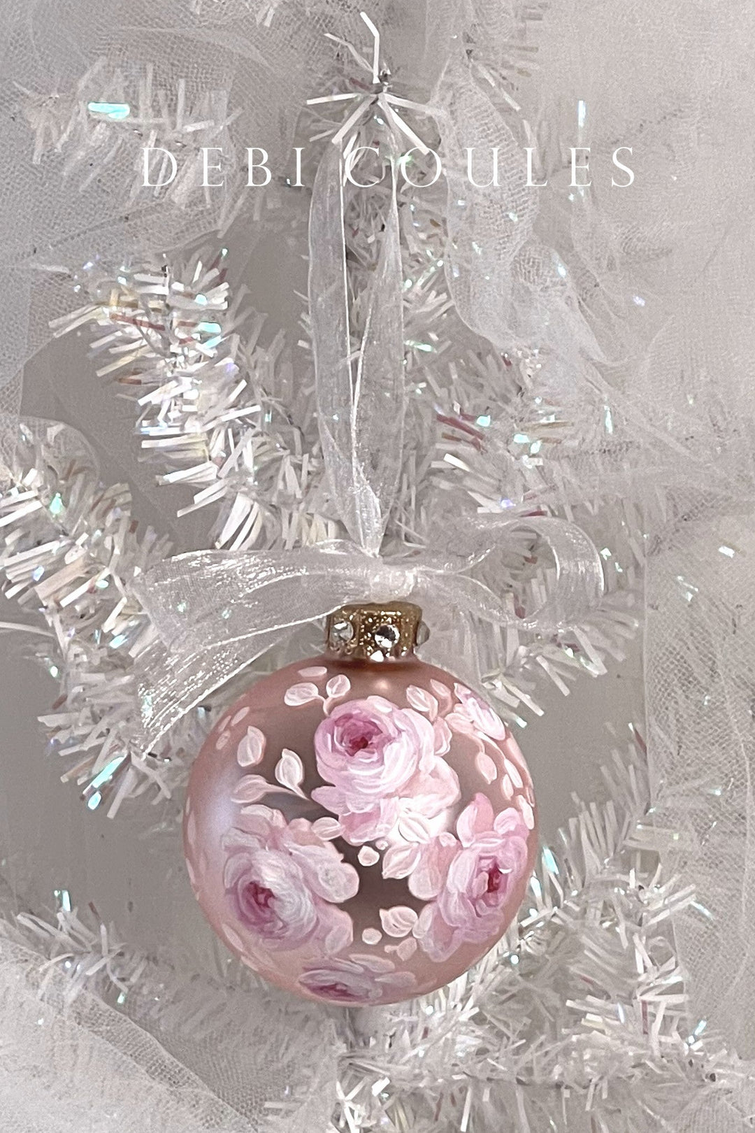 Hand-painted decorative Christmas ball ornament with pink winter roses design on a tinsel background
