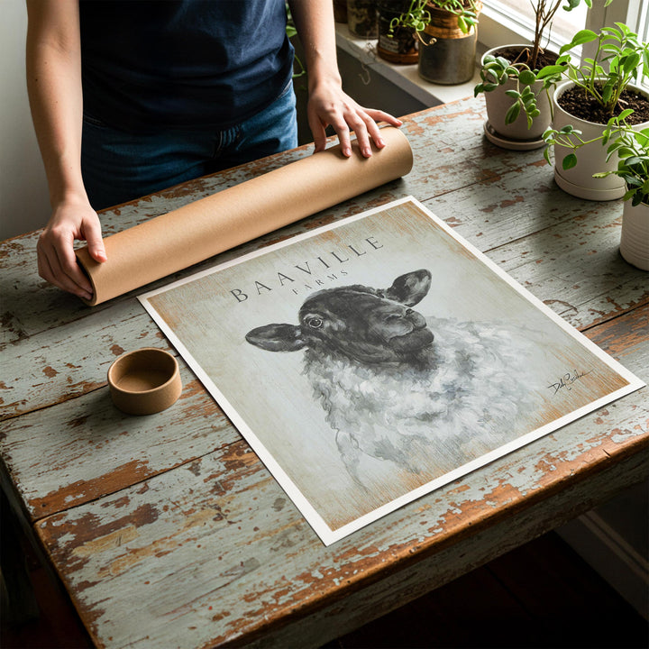 Person rolling up an unstretched canvas print of modern farmhouse sheep artwork to be placed in a cardboard mailing tube