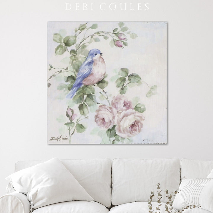 Shabby-chic canvas print of a singing bluebird hanging above a white couch