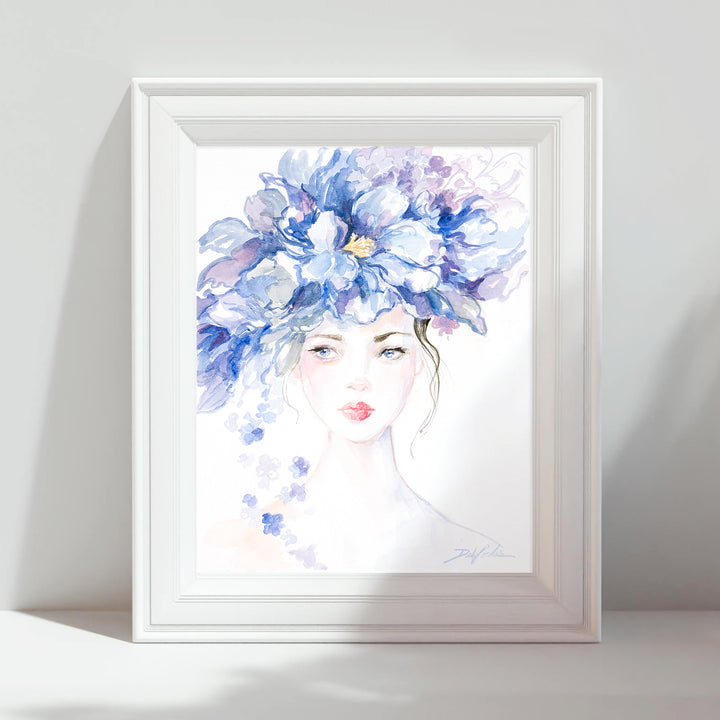Framed artwork of a woman with a blue floral headpiece on a white background
