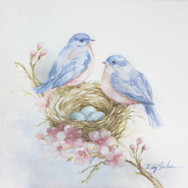 Watercolor featuring two bluebirds sitting on a nest with pink cherry blossoms around it.
