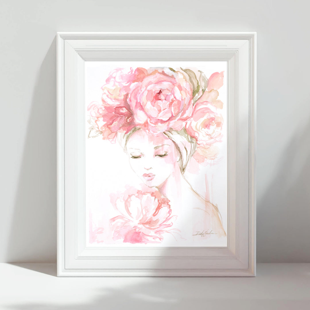 Framed artwork of a woman's face with pink flowers on a white background