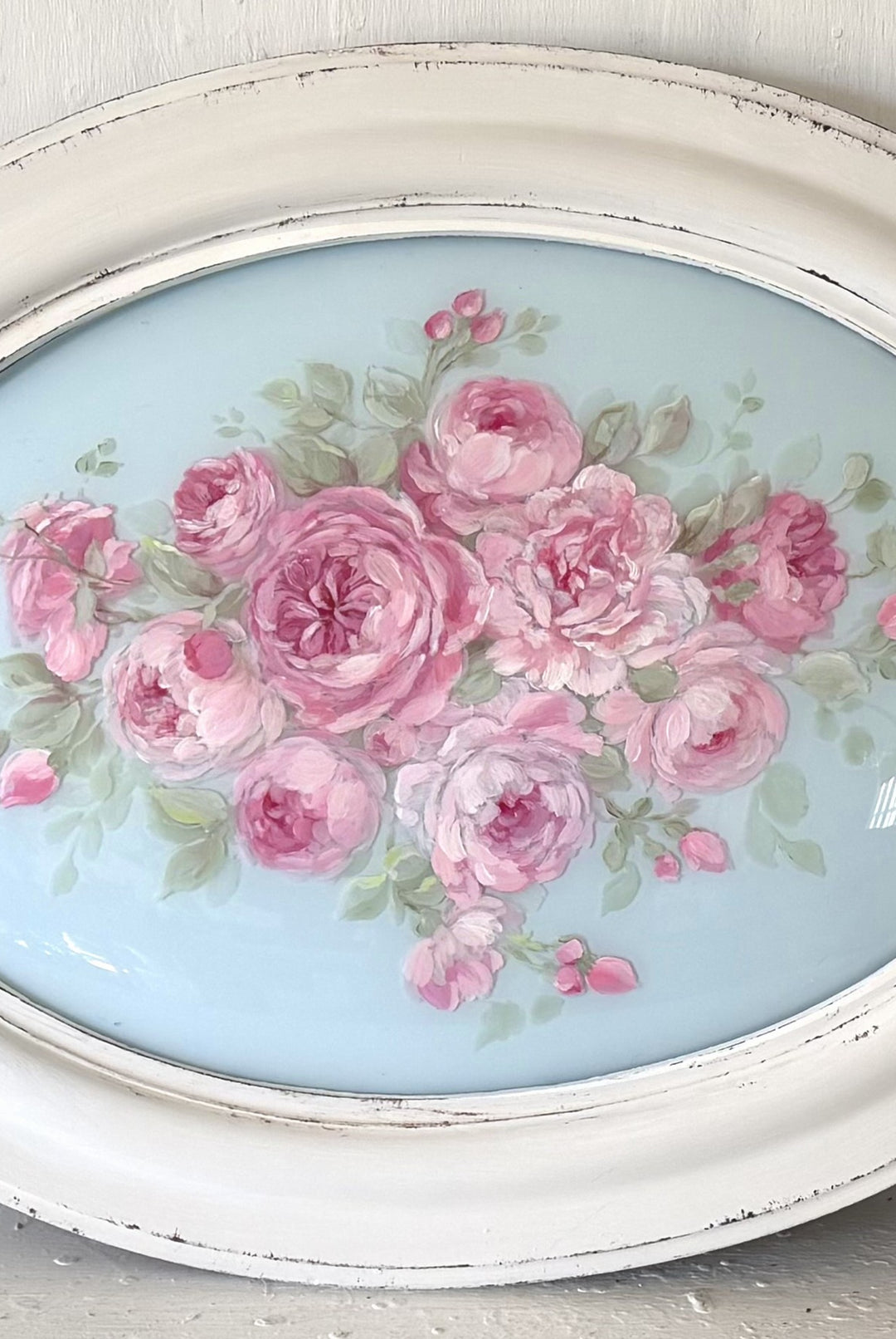 Antique bubble glass hand-painted with pink cabbage in a distressed white frame 