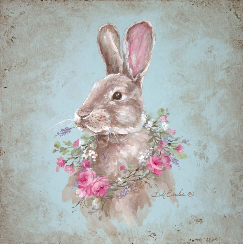 Painting of a bunny chewing on a sprig of lavender with a rose and wildflower wreath hanging around his neck. Painted on a light blue background with natural woodgrain and distressing.
