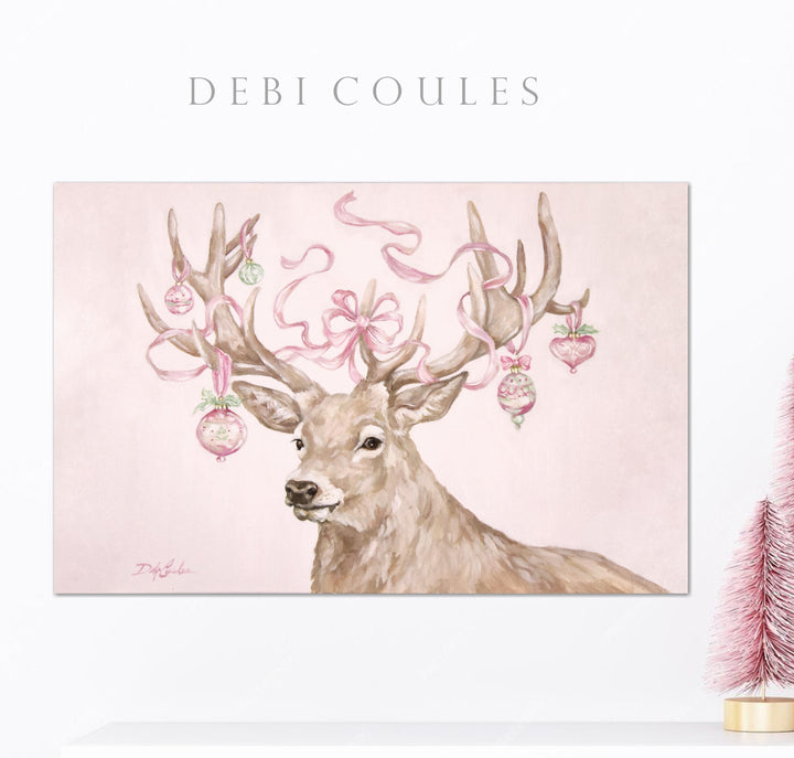 Decorative print of a deer with pink antlers and Christmas ornaments on a light pink background.