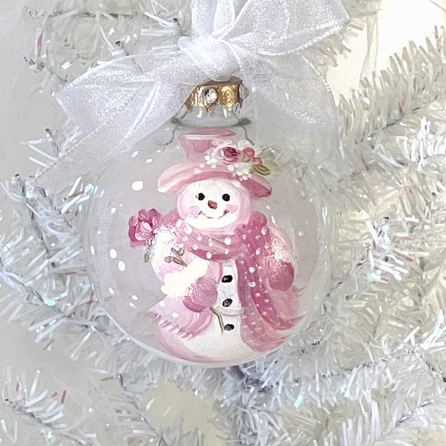 Glass Christmas ornament featuring a pink shabby-chic snowman