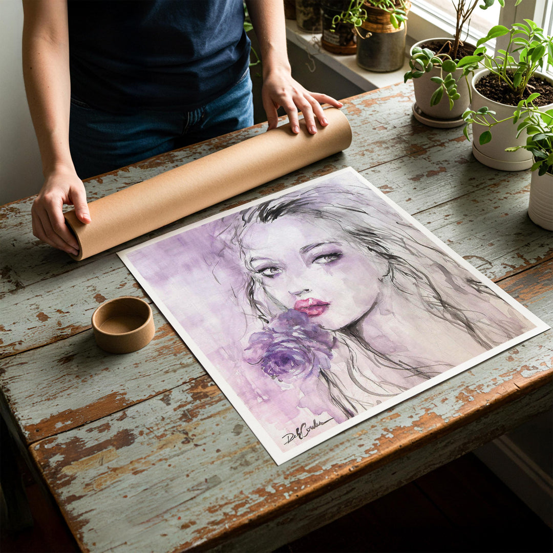 Person rolling up an unstretched canvas print of shabby chic fashion artwork to be placed in a cardboard mailing tube