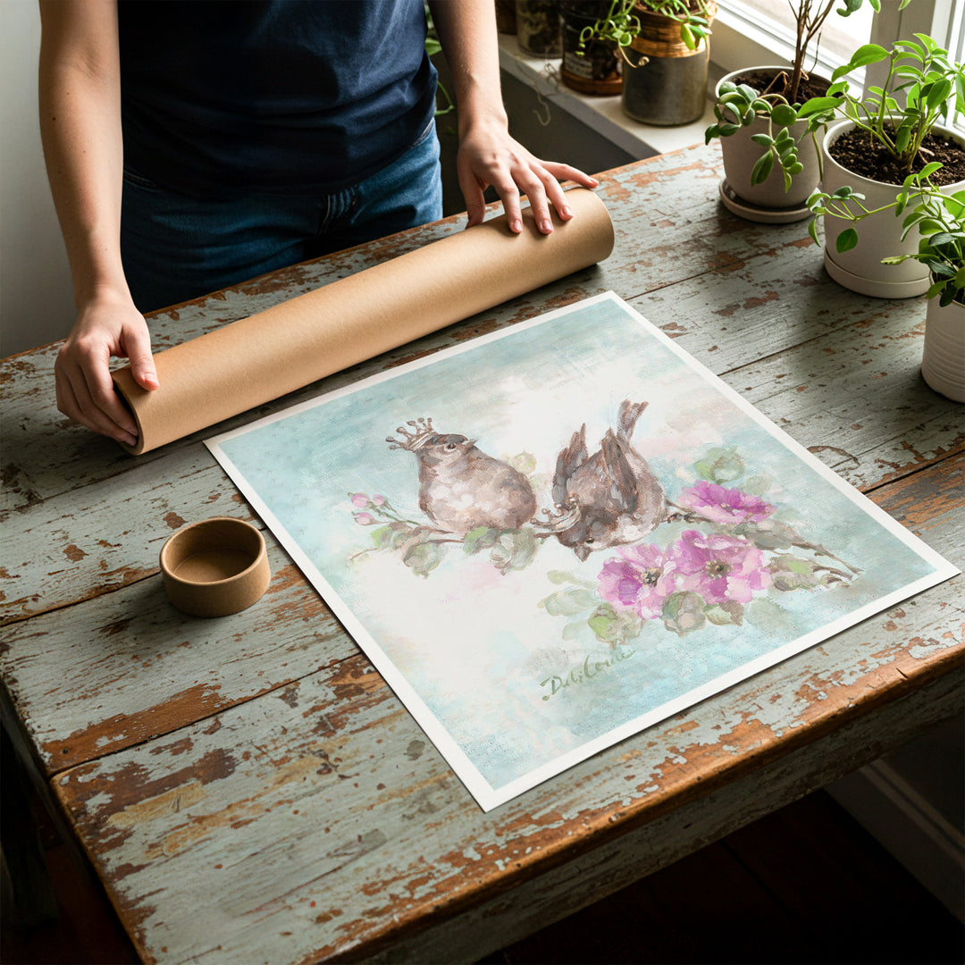 Person rolling up an unstretched canvas print of shabby chic crowned bird artwork to be placed in a cardboard mailing tube
