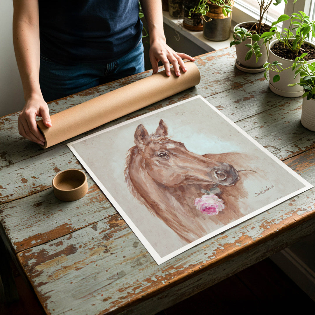 Person rolling up an unstretched canvas print of shabby chic horse artwork to be placed in a cardboard mailing tube