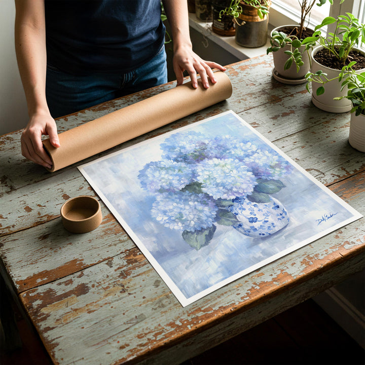 Person rolling up a fine-art paper print of shabby chic hydrangea artwork to be placed in a cardboard mailing tube