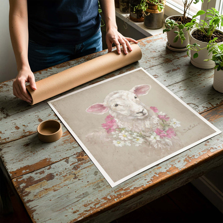 Person rolling up an unstretched canvas print of shabby chic sheep artwork to be placed in a cardboard mailing tube