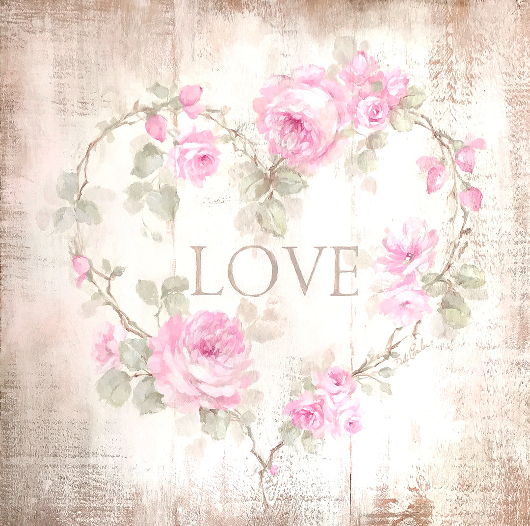 Shabby chic cottage sign with the word LOVE surrounded be roses with their stems twisted into a heart.