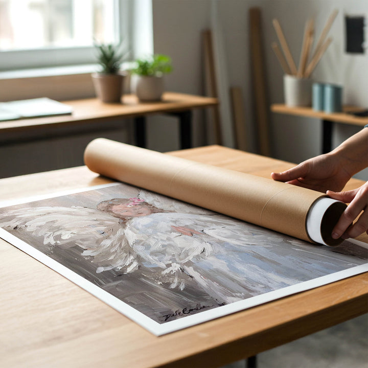 Person rolling a shabby-chic fine art print of an angel painting to place in a cardboard mailing tube.