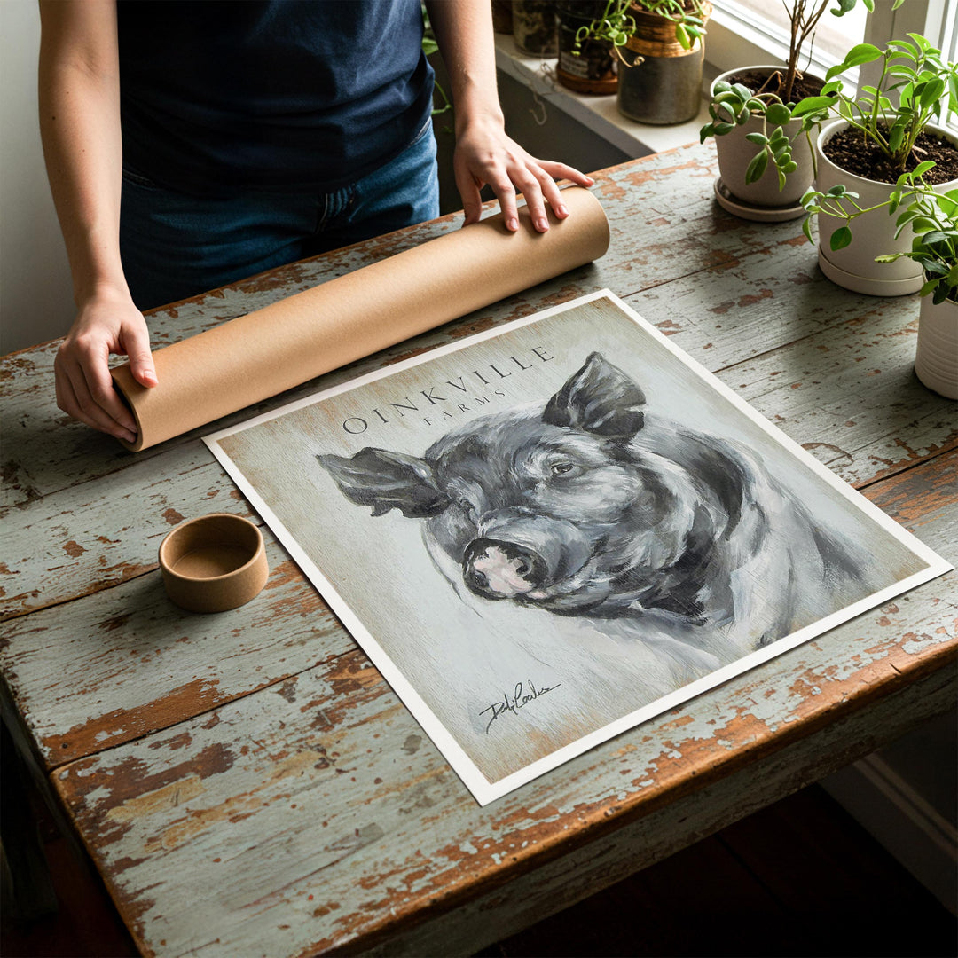 Person rolling up an unstretched canvas print of modern farmhouse pig artwork to be placed in a cardboard mailing tube