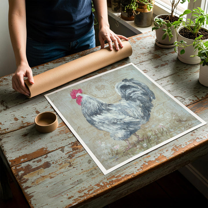 Person rolling up an unstretched canvas print of shabby chic rooster artwork to be placed in a cardboard mailing tube