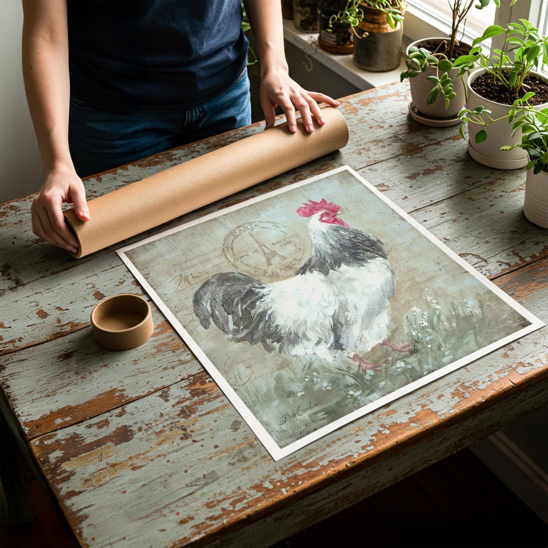 Person rolling up an unstretched canvas print of shabby chic rooster artwork to be placed in a cardboard mailing tube