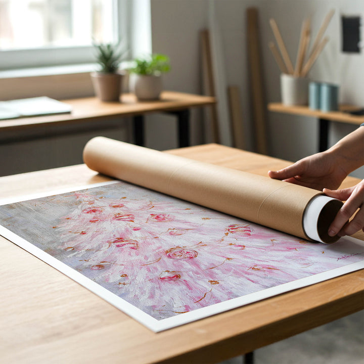 A person rolling up an unstretched canvas print of shabby-chic pink christmas painting to place in a cardboard mailing tube.