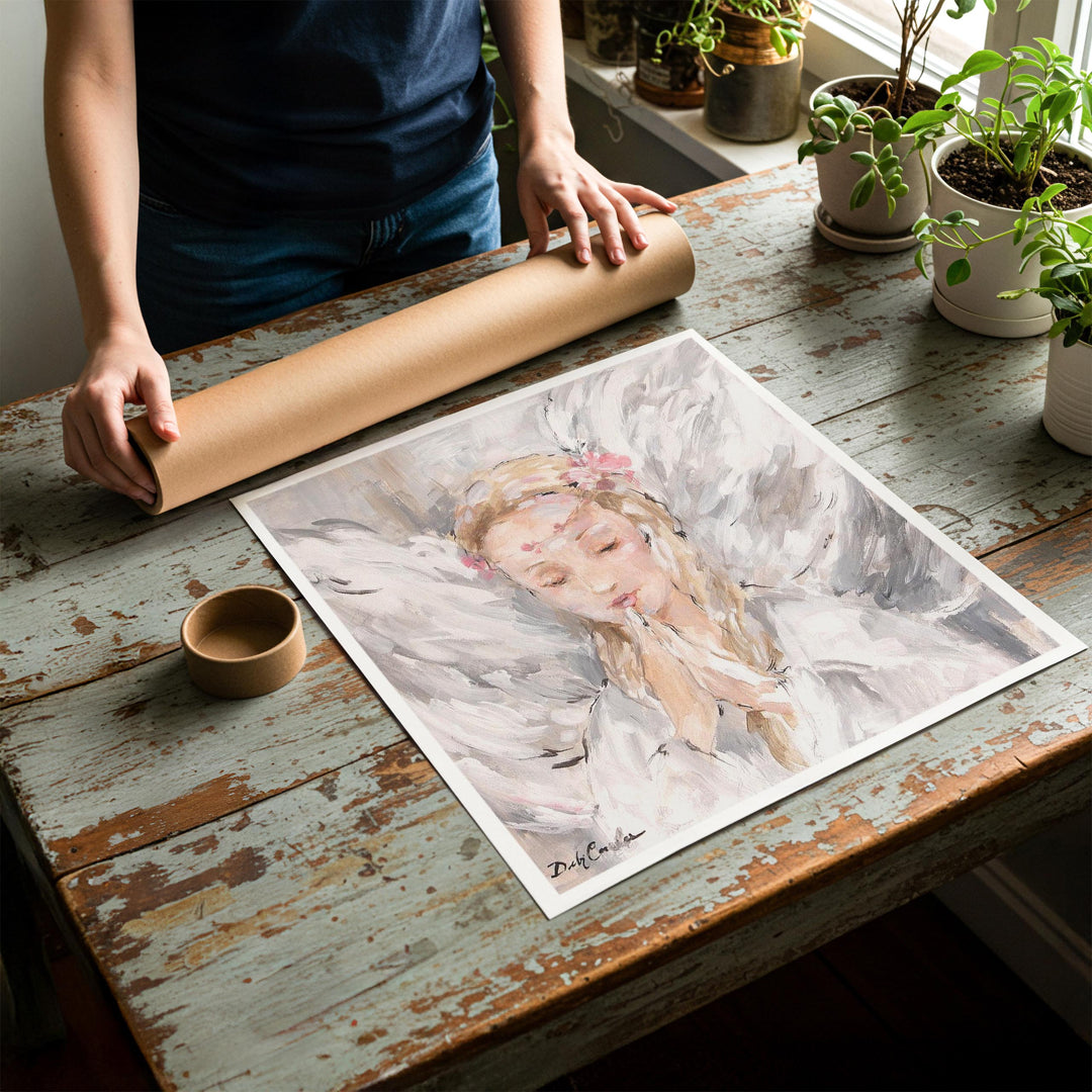 Person rolling up an unstretched canvas print of shabby chic angel artwork to be placed in a cardboard mailing tube