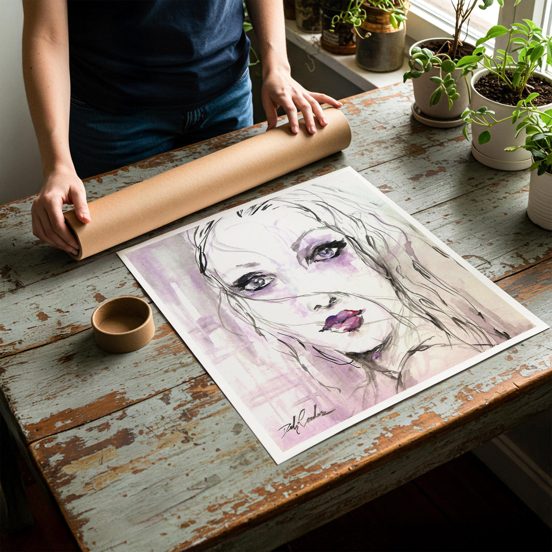 Person rolling up an unstretched canvas print of shabby chic fashion artwork to be placed in a cardboard mailing tube