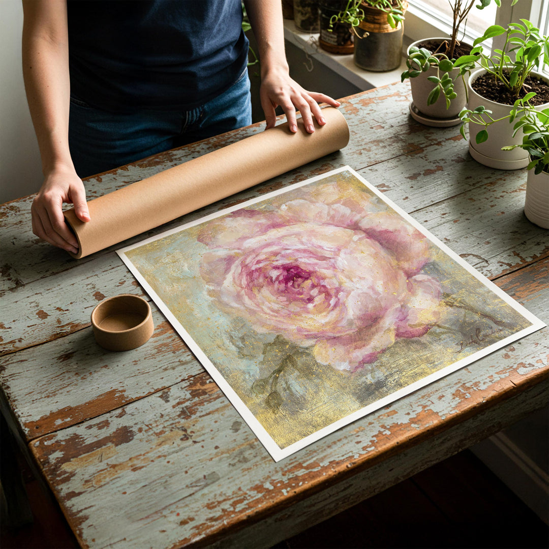 Person rolling up an unstretched canvas print of shabby chic rose artwork to be placed in a cardboard mailing tube