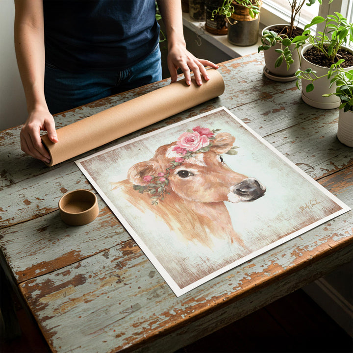 Person rolling up an unstretched canvas print of shabby chic cow artwork to be placed in a cardboard mailing tube