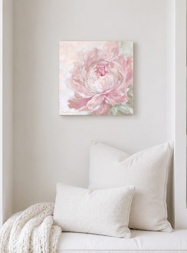 Softly Unfolding pink peony wall art displayed above a white sofa in a light, airy bedroom, featuring soft blush pink petals and pale green leaves.