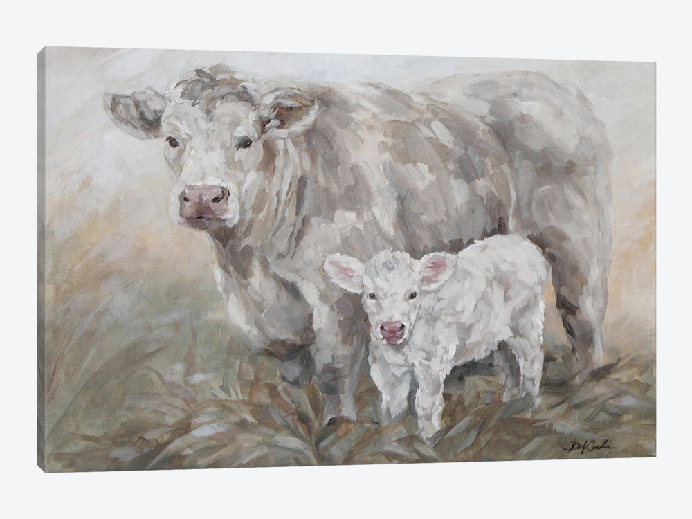 Canvas print a mother cow and a calf standing together in a field.