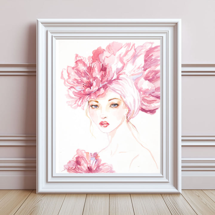Framed artwork of a woman with a large pink flower in her hair on a wall.