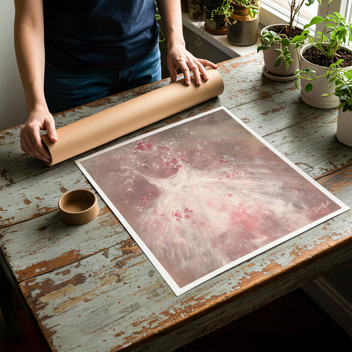 Person rolling up an unstretched canvas print of shabby chic ballet artwork to be placed in a cardboard mailing tube
