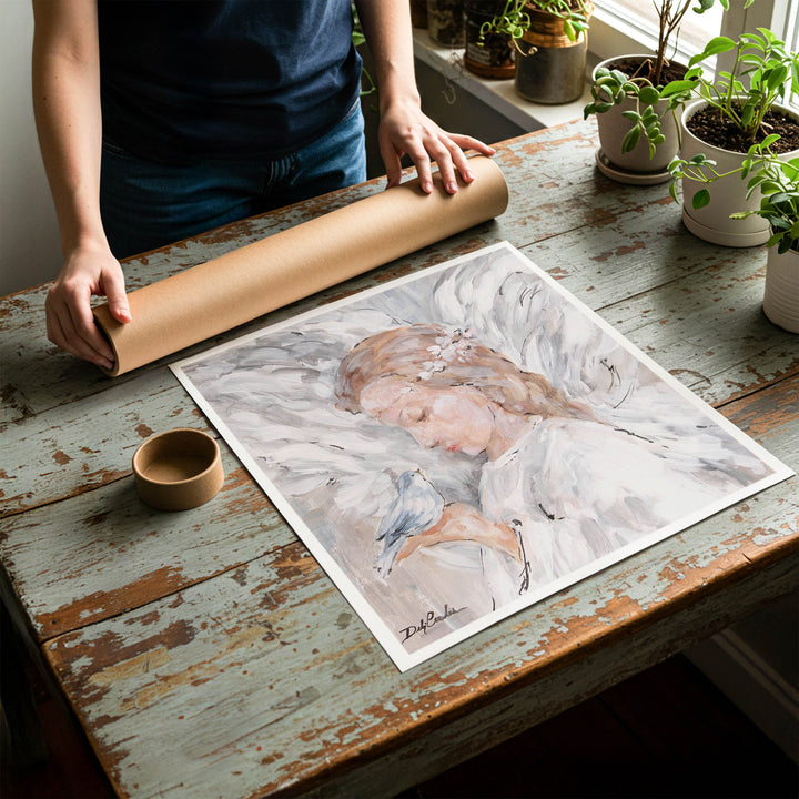 Person rolling up a fine-art paper print of shabby chic angel artwork to be placed in a cardboard mailing tube