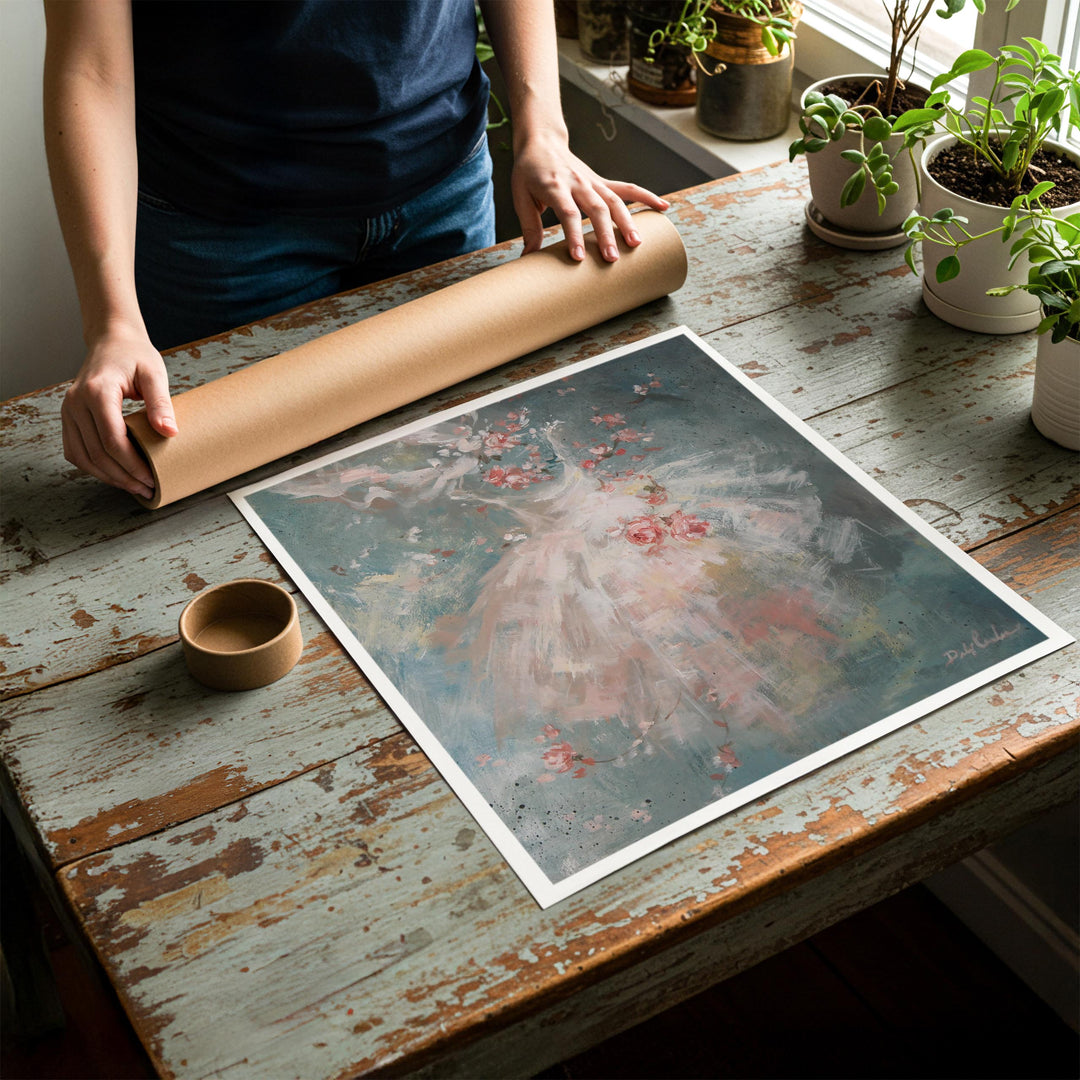 Person rolling up an unstretched canvas print of shabby chic ballet artwork to be placed in a cardboard mailing tube