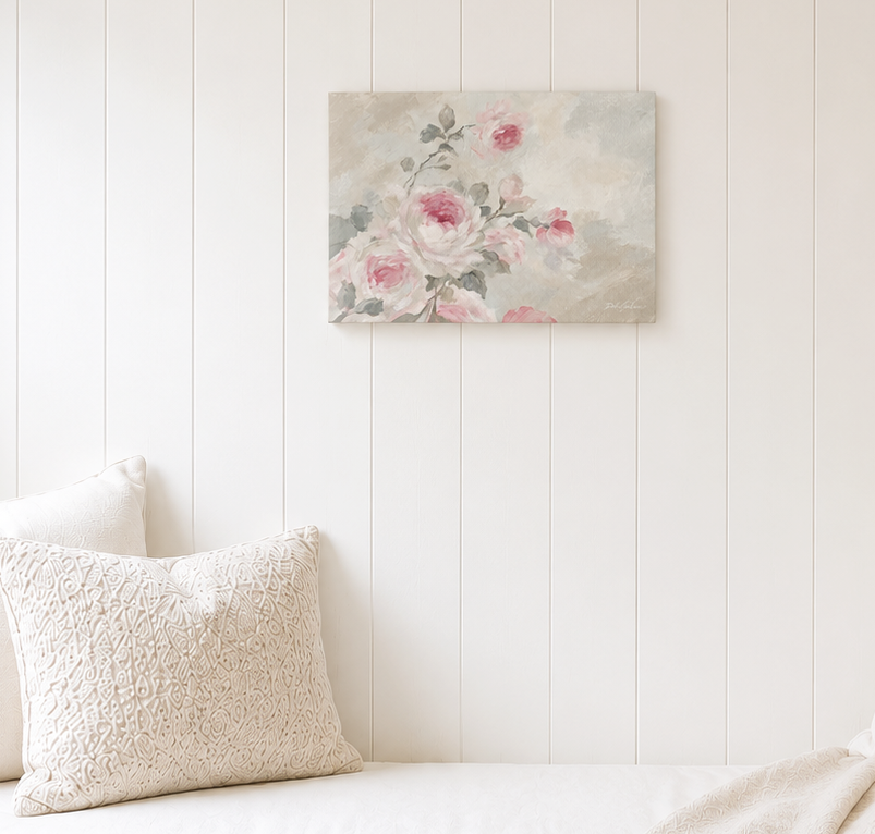 Rose floral wall art mounted on a white panel wall above a sofa with a textured pillow.