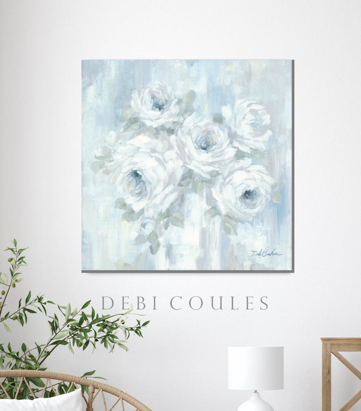Canvas print of white and blue roses hanging on a white wall