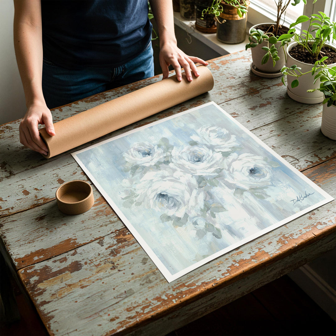 Person rolling up a fine-art paper print of shabby chic rose artwork to be placed in a cardboard mailing tube