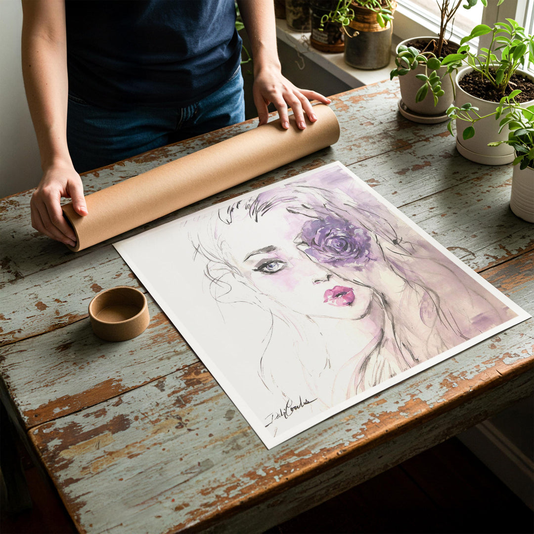 Person rolling up an unstretched canvas print of shabby chic fashion artwork to be placed in a cardboard mailing tube