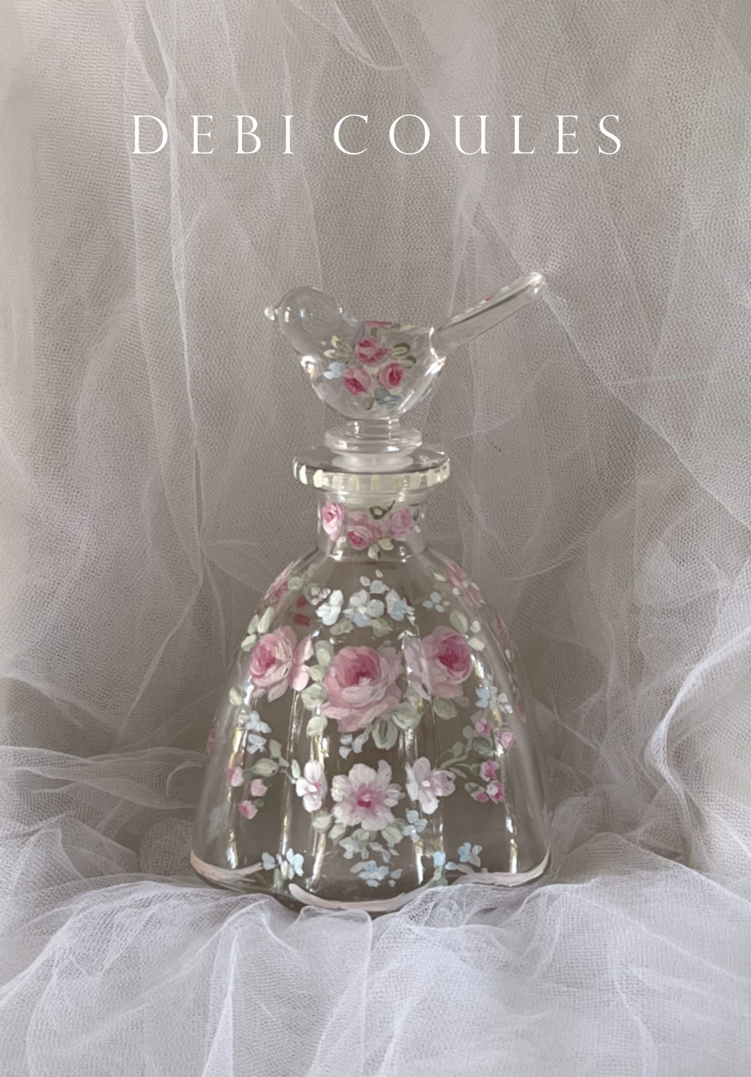 Charming hand painted glass perfume bottle with French roses, shades of pink and white. blue and white wildflowers mingle, Scalloped edges, bird stopper also has roses. Original Vintage Shabby Chic look by Debi Coules