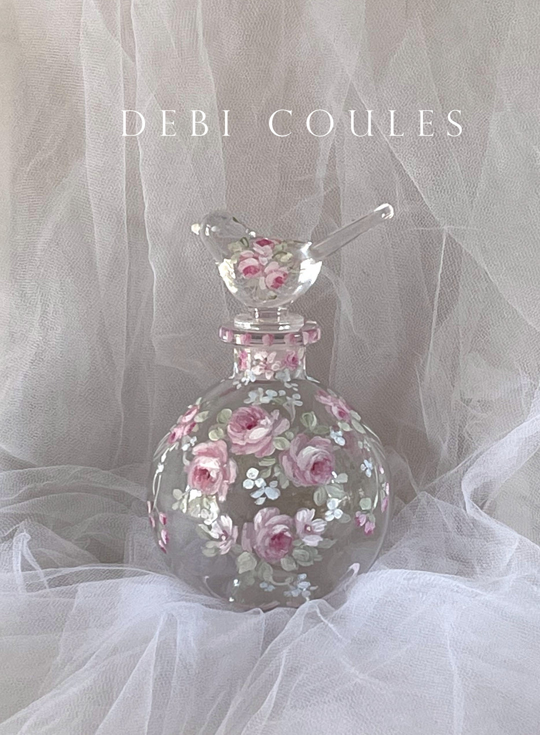 Charming hand painted glass perfume bottle with French roses, shades of pink and white. blue and white wildflowers mingle, bird stopper also has roses. Original Vintage Shabby Chic look by Debi Coules