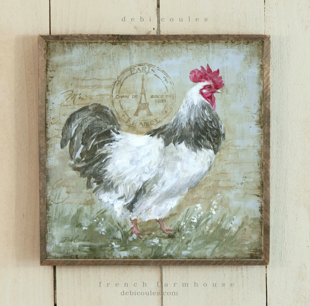 White and black rooster standing in green grass and wildflowers, French Eifel Tower postage stamp with Paris writing in background. Rustic Barnwood style frame. by Debi Coules Artist, French, Shabby Chic, Cottage, Farmhouse style home wall décor.